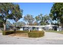 House exterior showcasing a well-maintained lawn and driveway at 5775 Bayshore Dr, Seminole, FL 33772