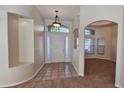 Bright entryway with tiled floor, neutral walls, and access to other rooms at 6013 Catlin Dr, Tampa, FL 33647
