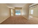 Spacious living room with view of the pool and access to other rooms at 6013 Catlin Dr, Tampa, FL 33647
