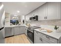Modern gray kitchen with stainless steel appliances at 6211 Timber Lake Dr # B8, Sarasota, FL 34243