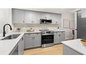 Modern kitchen with gray cabinets and quartz countertops at 6211 Timber Lake Dr # B8, Sarasota, FL 34243