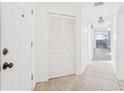 Bright entryway with tiled flooring, a coat closet, and views to the living area at 6833 S Wall St, Tampa, FL 33616