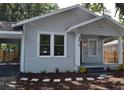 Renovated craftsman home with gray siding, front porch, and landscaping at 8010 N 11Th St, Tampa, FL 33604