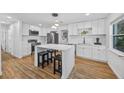 Modern kitchen with white cabinets, stainless steel appliances, and an island at 1558 13Th S St, St Petersburg, FL 33705