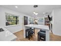 Open concept kitchen and living area with island and hardwood floors at 1558 13Th S St, St Petersburg, FL 33705