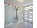Entryway with double front doors, sliding barn door, and tile floors at 16117 Medrick Rd, Brooksville, FL 34614