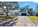 Charming updated home with spacious driveway and green lawn at 1750 Georgia Ne Ave, St Petersburg, FL 33703