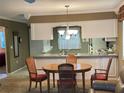 Dining area adjacent to the kitchen with a view into the kitchen at 2280 Bancroft S Cir # A, Palm Harbor, FL 34683
