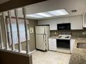 Bright, eat-in kitchen with white cabinets, granite countertops, and appliances at 2280 Bancroft S Cir # A, Palm Harbor, FL 34683