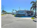 Street view of a manufactured home with palm trees in the background at 34462 Palm N Dr, Pinellas Park, FL 33781