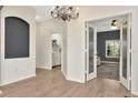 Entryway featuring modern lighting, neutral paint, and hard wood floors at 5021 Gato Del Sol Cir, Wesley Chapel, FL 33544