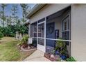 Inviting screened entryway with decorative plants and a welcome sign at 5021 Gato Del Sol Cir, Wesley Chapel, FL 33544