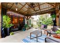 Relaxing outdoor patio with a covered pergola, seating, and stylish decor at 5021 Gato Del Sol Cir, Wesley Chapel, FL 33544