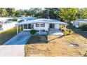 Single-wide manufactured home with covered patio and spacious yard at 5212 Betmar Dr, Zephyrhills, FL 33542