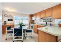 Cozy kitchen with light wood cabinets and a dining area at 5212 Betmar Dr, Zephyrhills, FL 33542