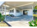 Covered patio with concrete flooring and potted plants at 5212 Betmar Dr, Zephyrhills, FL 33542