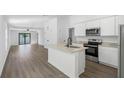 Modern kitchen featuring stainless steel appliances and an island at 12456 Ruffed Grouse Rd, Weeki Wachee, FL 34614