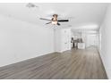 Open concept living room with wood-look flooring and access to the kitchen at 12456 Ruffed Grouse Rd, Weeki Wachee, FL 34614