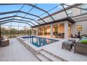 Relaxing screened-in pool with hot tub and covered patio, perfect for outdoor entertaining and leisure at 13019 Paddock Wood Pl, Riverview, FL 33579