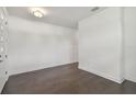 View of the entryway's dark wood floors, white walls, and simple ceiling light at 1530 W River Shore Way, Tampa, FL 33603