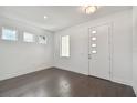 Entryway with white front door, dark wood floors, high ceilings, and multiple windows at 1530 W River Shore Way, Tampa, FL 33603
