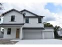 Charming two-story home featuring a double garage and a classic white exterior at 1530 W River Shore Way, Tampa, FL 33603