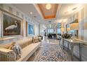 Inviting hallway with elegant décor, including paintings, a bench, and a stylish rug at 3 Seaside Ln # 601, Belleair, FL 33756