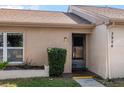 View of the home's entrance with a manicured lawn and walkway at 3954 Sailmaker Ln, Holiday, FL 34691
