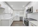Modern white kitchen with stainless steel appliances at 4511 Helena Ne St, St Petersburg, FL 33703