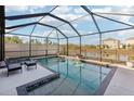 Inviting pool and screened patio with lake view, perfect for relaxing at 5808 Calla Lilly Dr, Sarasota, FL 34232