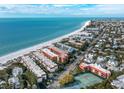 Aerial view showcasing beachfront property, ocean, and nearby town at 6006 Gulf Dr # 207, Holmes Beach, FL 34217