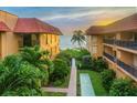 Ground level view of courtyard with shuffleboard and ocean access at 6006 Gulf Dr # 207, Holmes Beach, FL 34217