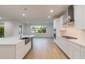Bright kitchen with modern appliances, large island, and natural light flooding in from a large window at 809 W Indiana Ave, Tampa, FL 33603
