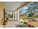 Inviting front porch with light blue ceiling and potted plants at 103 W Elm St, Tampa, FL 33604