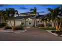 Modern home showcasing a grand entrance, lush landscaping, and circular brick driveway at 123 8Th E St, Tierra Verde, FL 33715