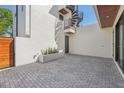 Private outdoor patio with paved brick and white walls. Modern exterior design at 1412 S Moody Ave # A, Tampa, FL 33629