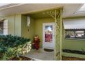 Front entryway features a red door, decorative metalwork, and festive decorations at 1521 San Helen Dr, Dunedin, FL 34698