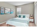 Relaxing bedroom with wood-style flooring, a comfortable bed, and nature-inspired artwork at 1799 N Highland Ave # 28, Clearwater, FL 33755