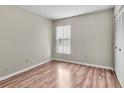 Spacious bedroom featuring wood-look flooring and large window at 1799 N Highland Ave # 28, Clearwater, FL 33755