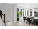 Dining area with modern light fixture, large windows, and stylish furniture at 432 43Rd Ne Ave, St Petersburg, FL 33703
