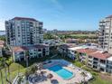 Aerial view of condo community pool with surrounding patio and building at 6372 Palma Del Mar S Blvd # 505, St Petersburg, FL 33715