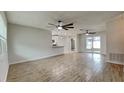 Open living room with wood-look tile floors and ceiling fans at 1701 Hibiscus S Cir, Oldsmar, FL 34677