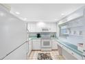 Bright kitchen with white cabinets and appliances at 7871 Sailboat Key S Blvd # 106, South Pasadena, FL 33707