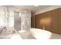 Modern bathroom featuring marble walls, a soaking tub, and double vanity at 1260 Wellington Dr, Clearwater, FL 33764