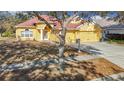 Charming two-story home with a red tile roof, nestled among trees at 16829 Midsummer Ln, Spring Hill, FL 34610