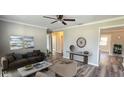 Comfortable living room with wood-look floors, ceiling fan, and neutral wall colors at 1722 St Croix Dr, Clearwater, FL 33759