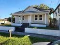 Quaint single-story home with a covered front porch and a well-maintained lawn at 2120 W Beach St, Tampa, FL 33607