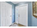 Bright entryway with white front door, sidelight, and tiled floor at 637 Pinellas Bayway S # 111, St Petersburg, FL 33715