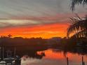 Stunning sunset view over the canal with palm trees in the foreground at 637 Pinellas Bayway S # 111, St Petersburg, FL 33715