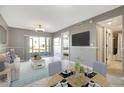 Living room with dining area, view of the patio and waterfront, and access to the bathroom at 6923 Stonesthrow N Cir # 4105, St Petersburg, FL 33710